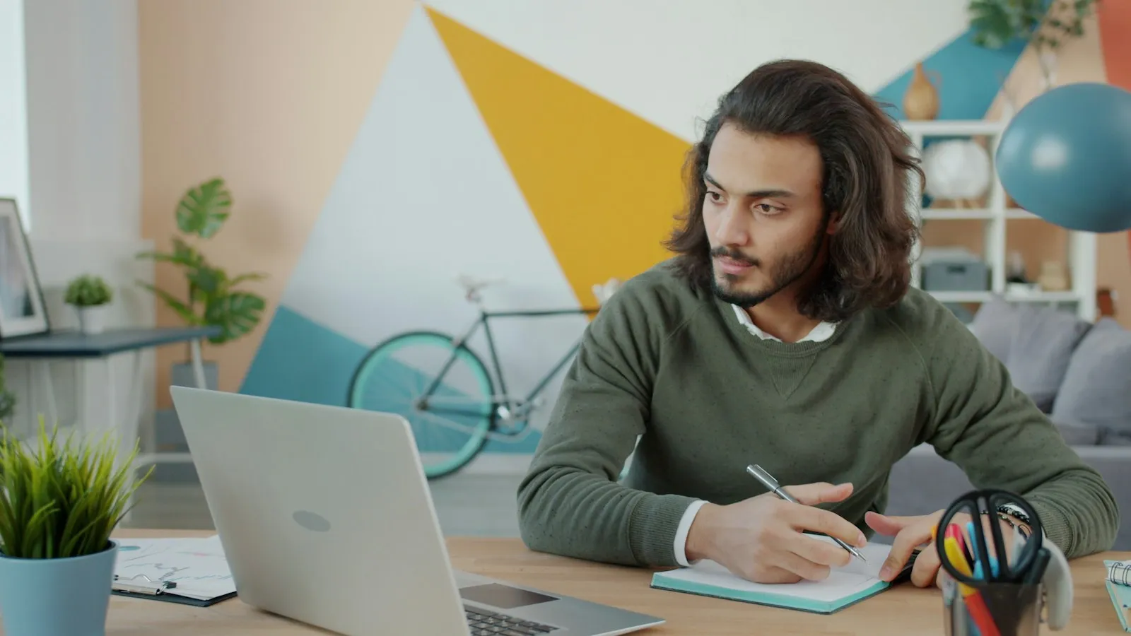 Freelancer working at a desk with a laptop and notebook